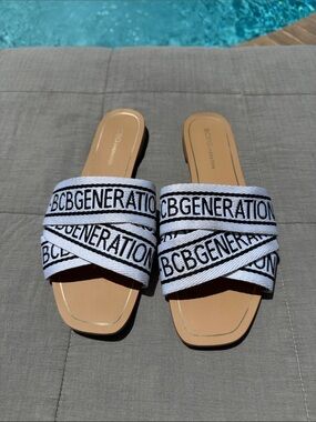 BCBGeneration White and Black Logo Crisscross Slide Sandals